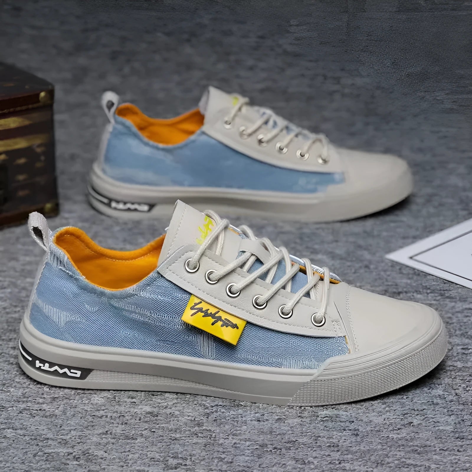 Men's dark blue canvas lace-up shoes with a round toe and white rubber sole on a neutral background.