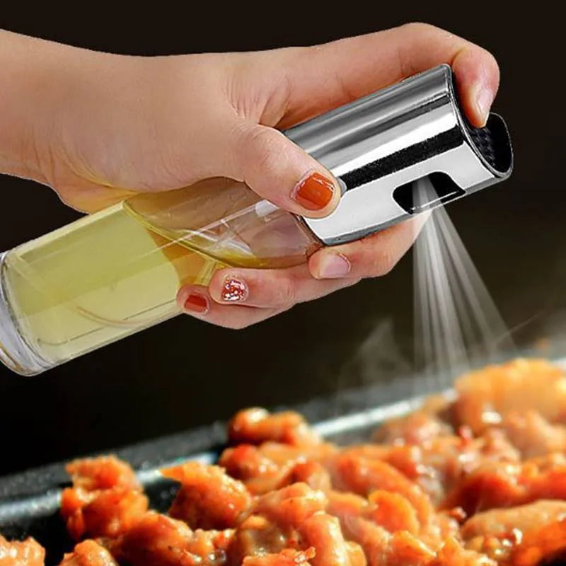 Gold push-type oil and vinegar spray bottle made of ABS plastic and glass with pump top.