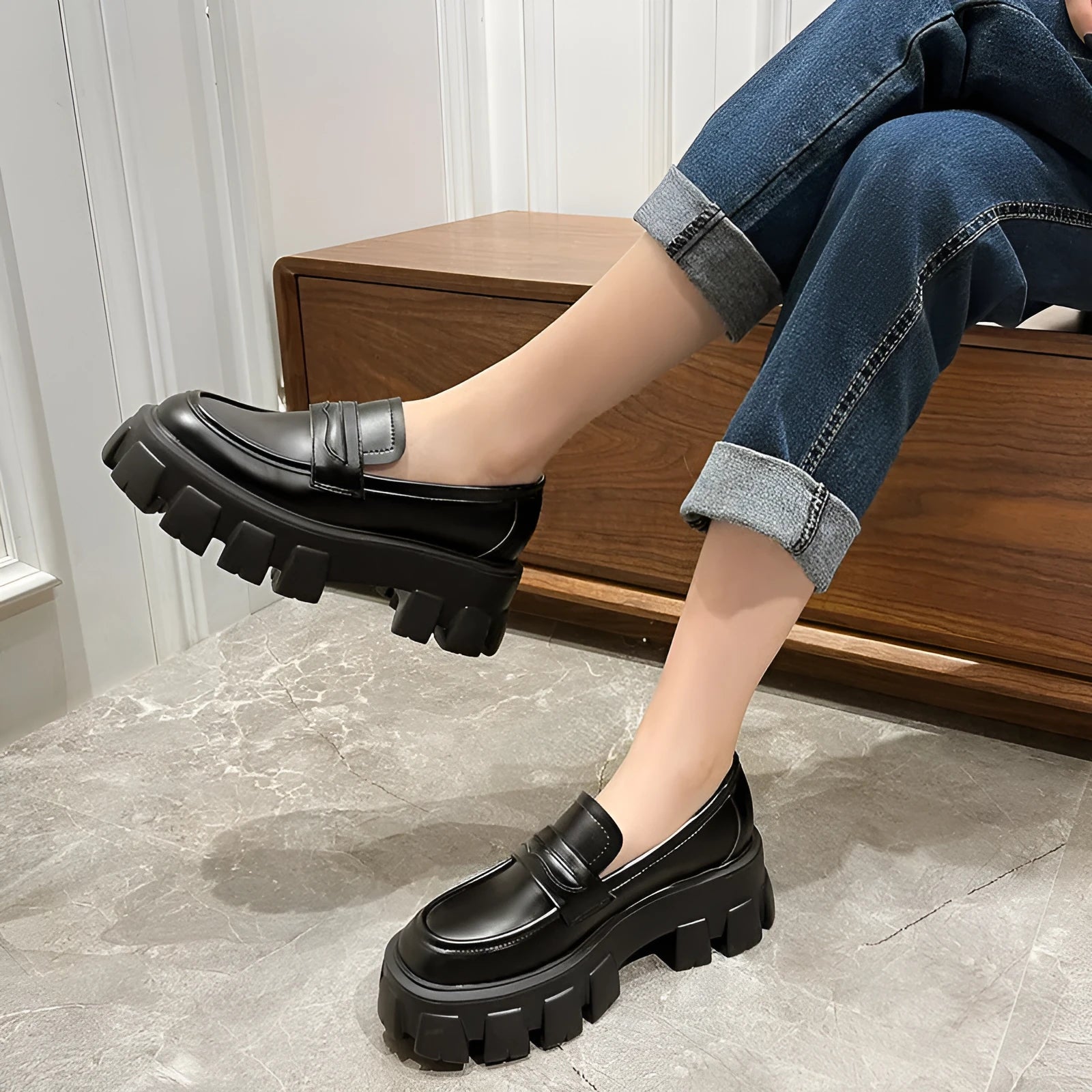 Women's wide fit patent leather loafers with a muffin heel and shallow opening on a rubber sole.