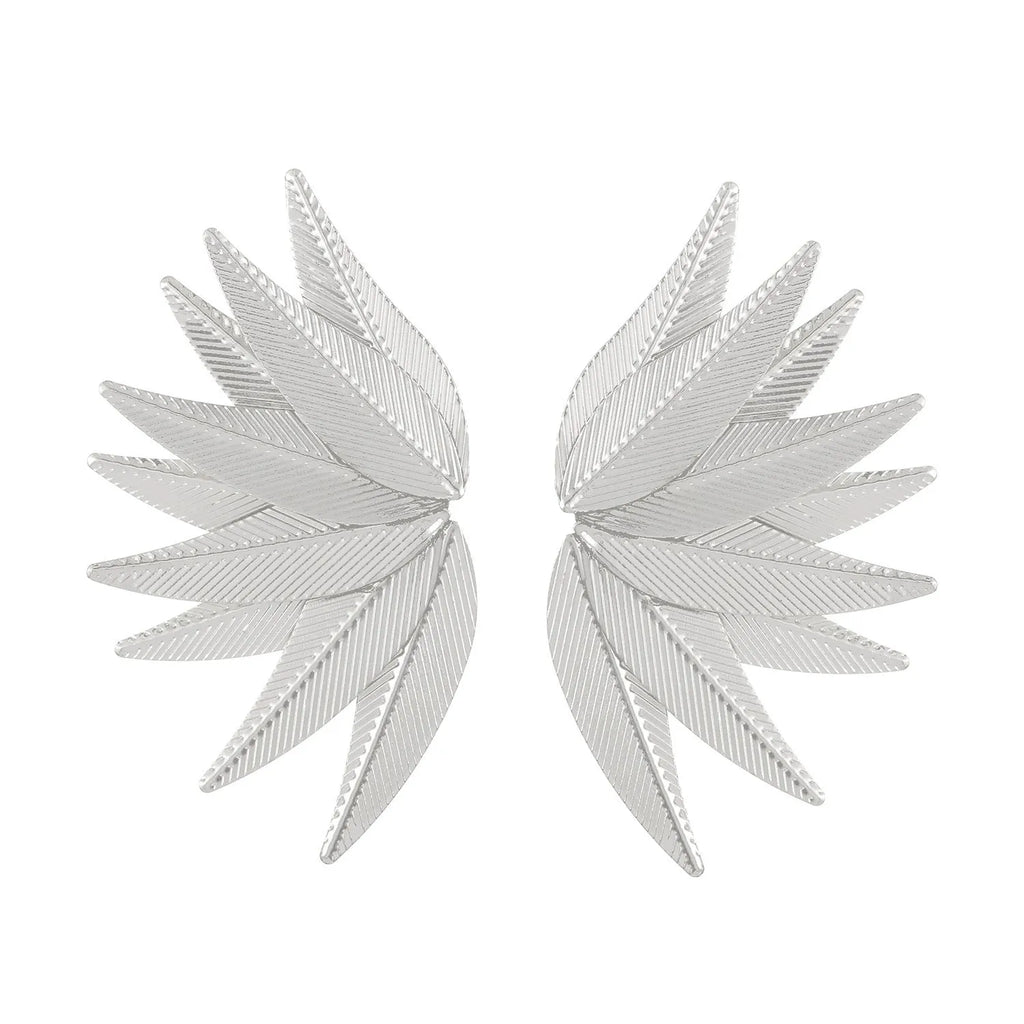 A pair of gold and white alloy patch earrings shaped like leaves.