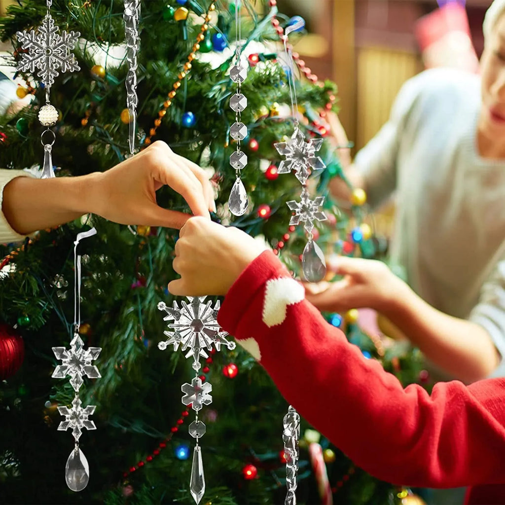 Set of ten clear acrylic icicle and snowflake Christmas ornaments with white hanging ribbons.