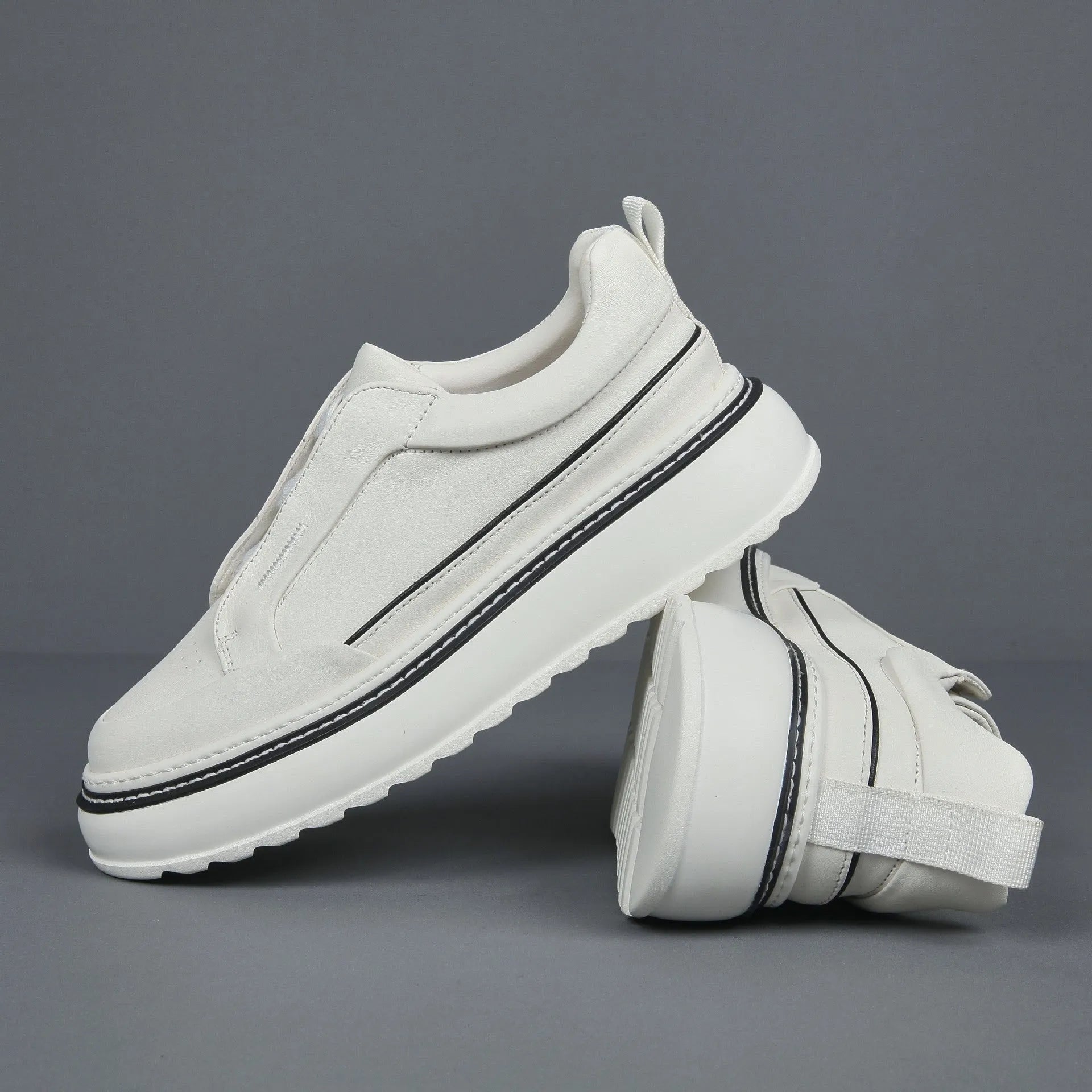 Black casual slip-on sneaker with leather upper, foam platform sole, and elastic band – side view