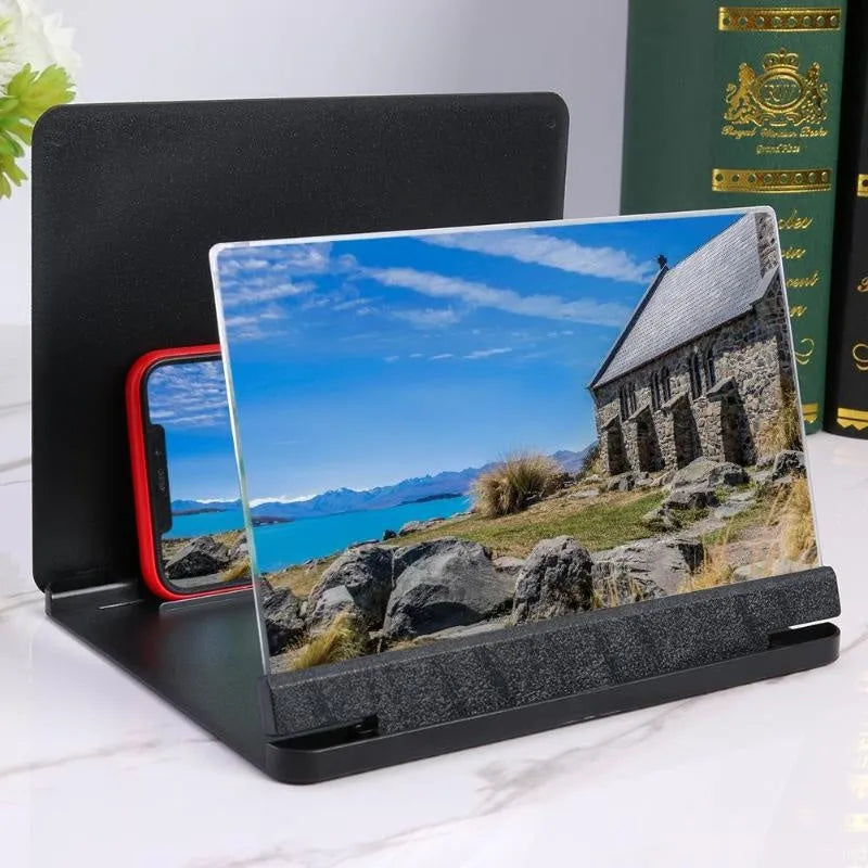 White and black smartphone screen magnifier with integrated phone holder on a table.