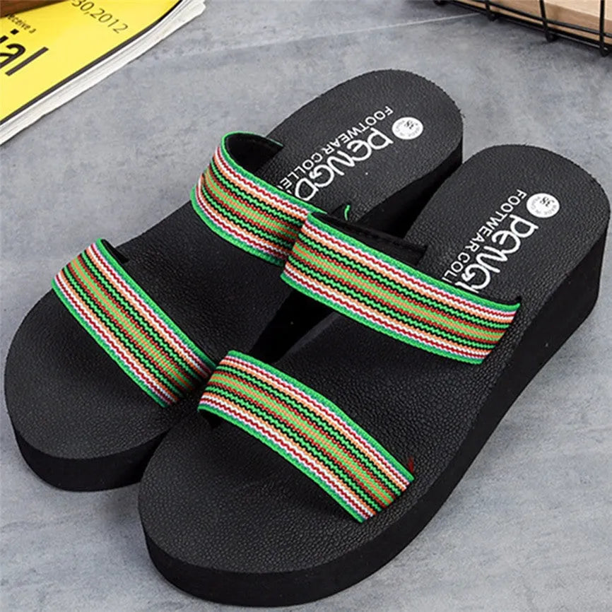 Women's brown bohemian wedge slippers with elastic strap on a wooden floor.
