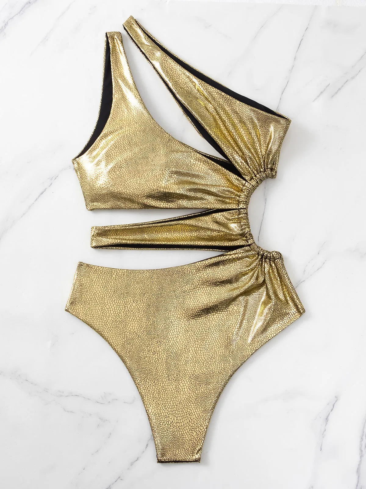 Gold backless one-piece swimsuit for women on a mannequin, showing sleeveless design.