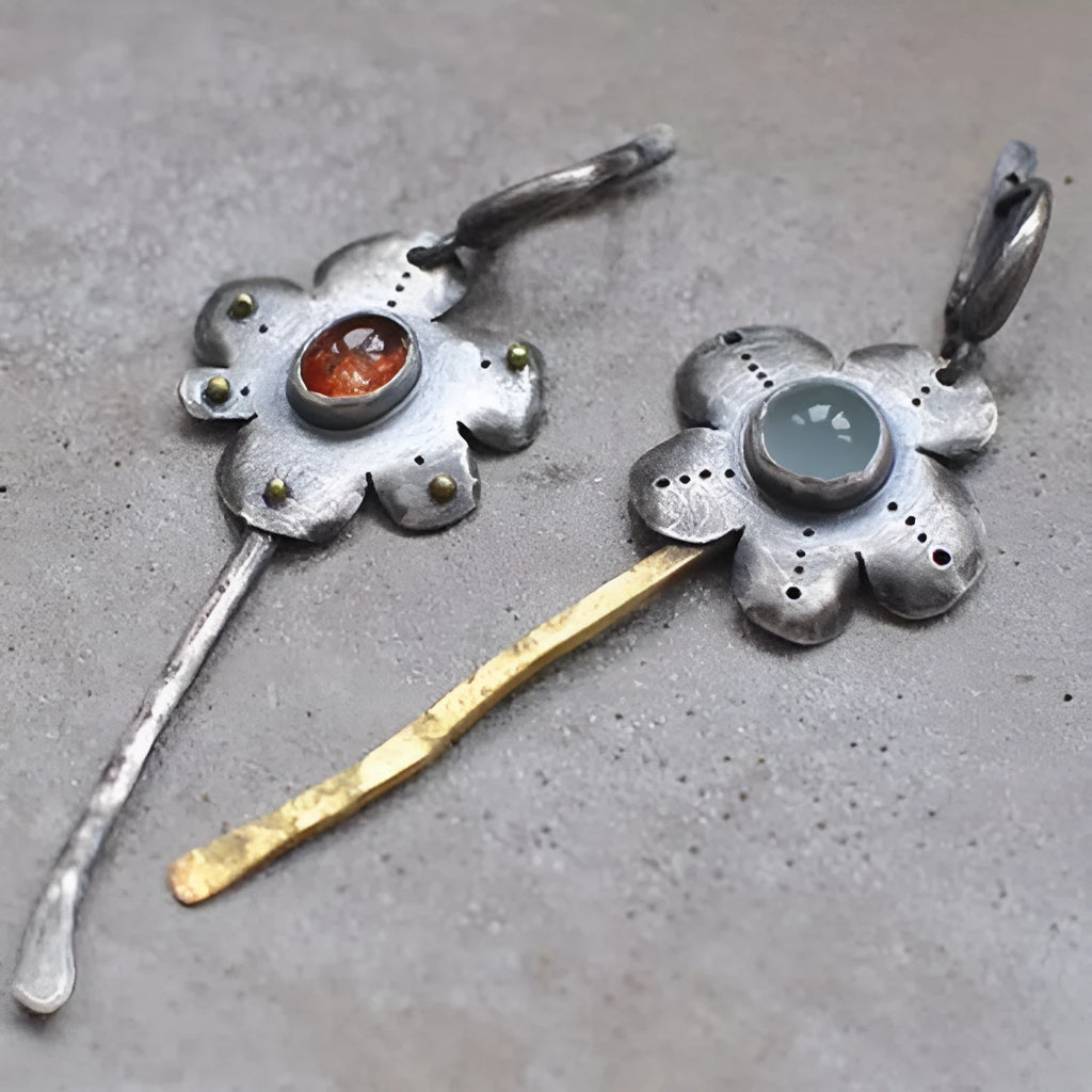Long retro earrings with two-tone floral geometric design in alloy with electroplated finish.