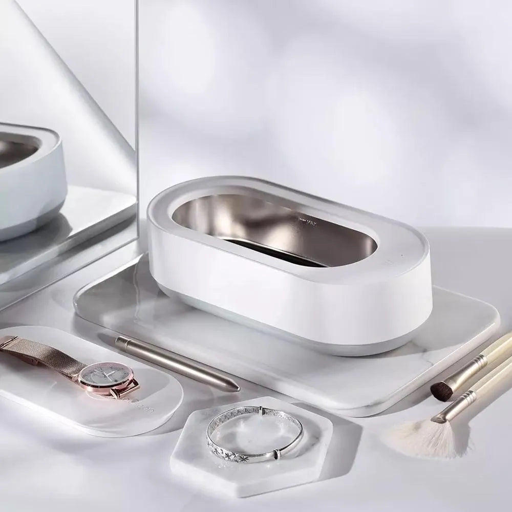 White portable ultrasonic cleaner with stainless steel tank and touch button.