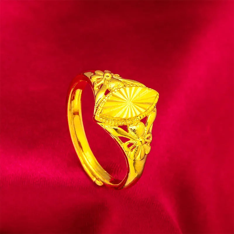 Gold openwork geometric flower ring with a textured alluvial pattern on a brass base.