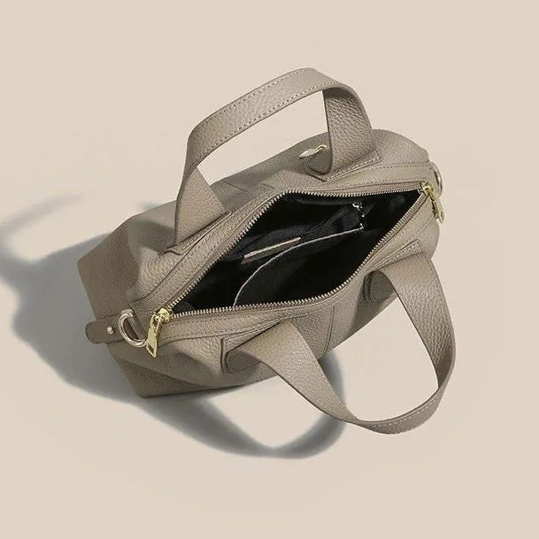 Women's leather cross-body shoulder bag in horizontal square shape with multiple internal zipped compartments