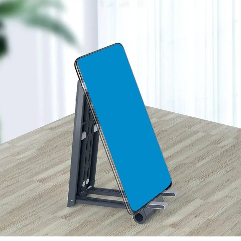Grey multifunctional laptop stand with seven-shaped silicone grip on a flat surface