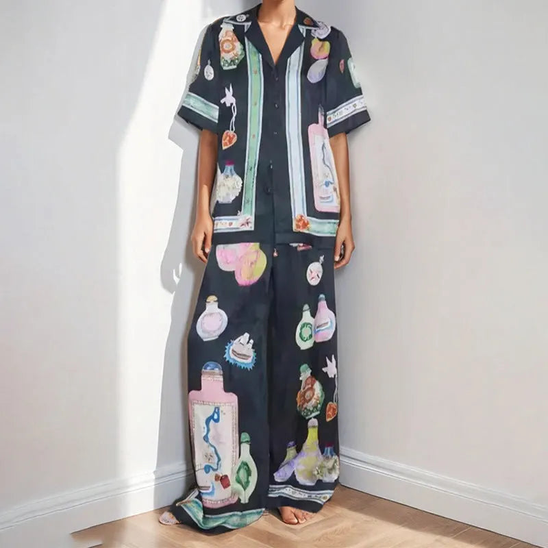 Black women's two-piece cardigan and trousers set with a cartoon animation pattern print.