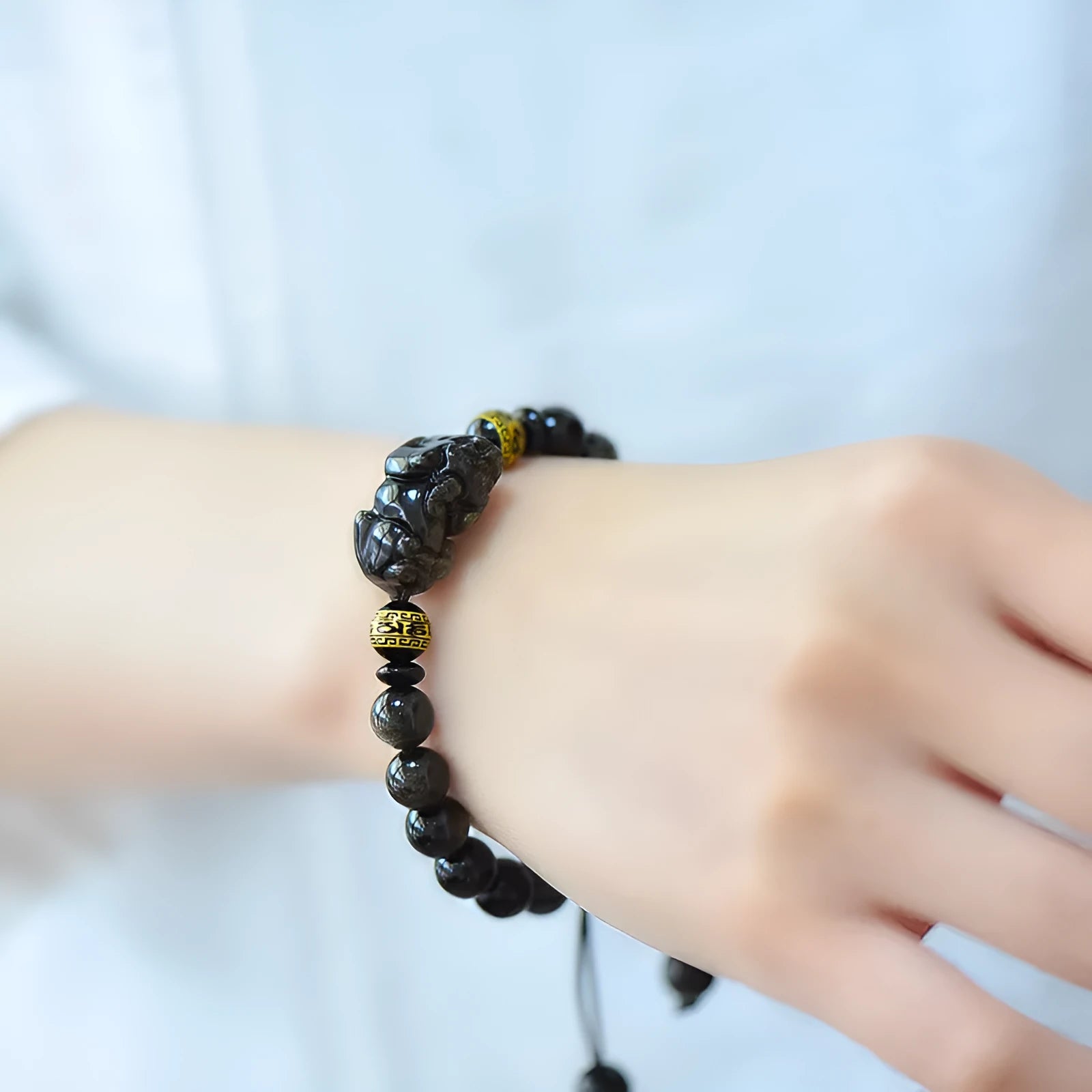 Hand-woven golden obsidian bracelet with Pi Xiu charm in 8mm, 10mm, 12mm, and 14mm bead sizes.