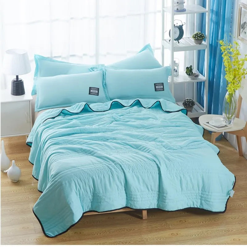 Pure colour seersucker cooling air-conditioning quilt laid flat on a bed