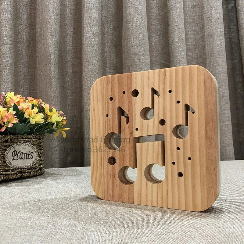 Natural pine wood cube LED atmosphere lamp with warm white glow on a desk.