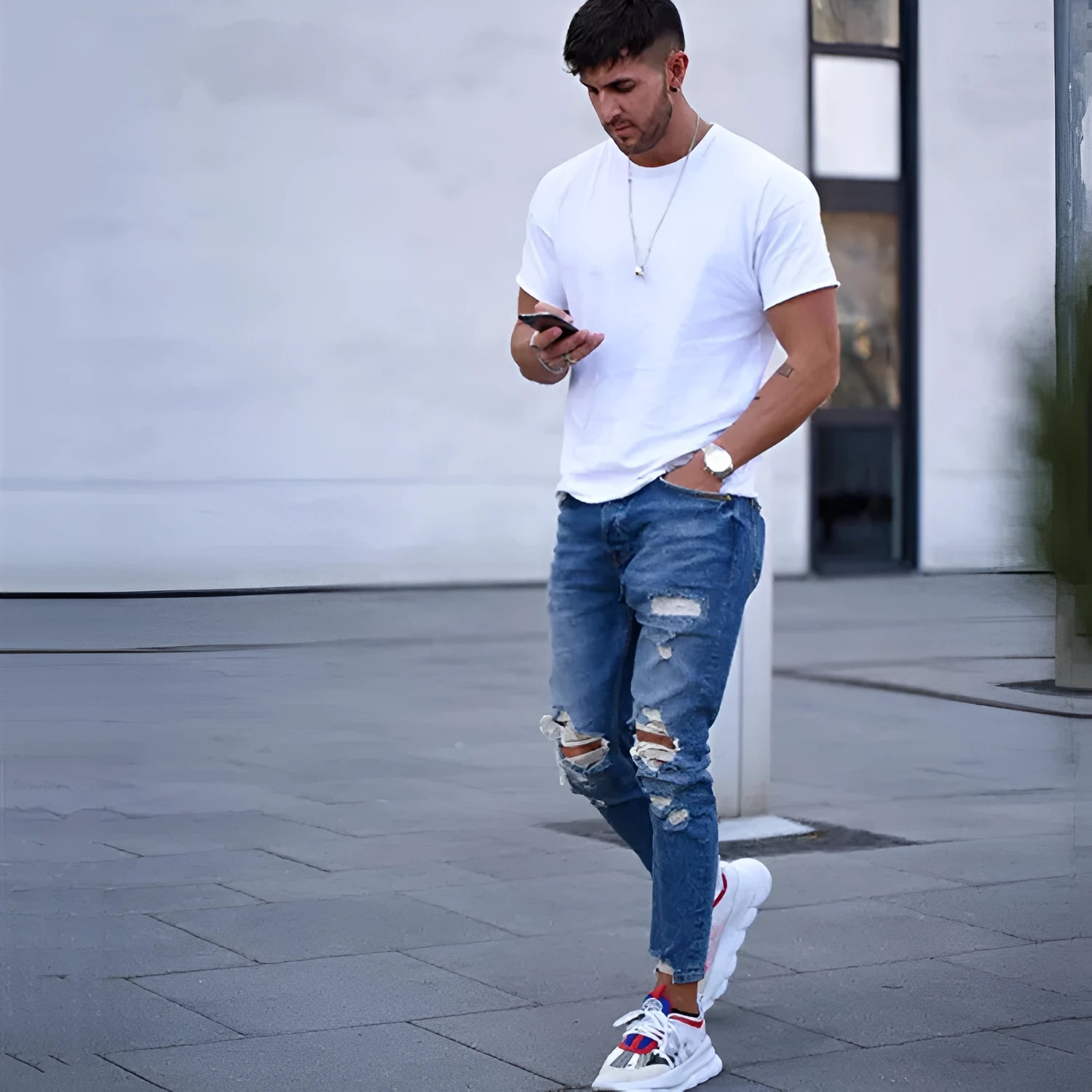 Men's deep blue cotton jeans with hole distressing, shown flat