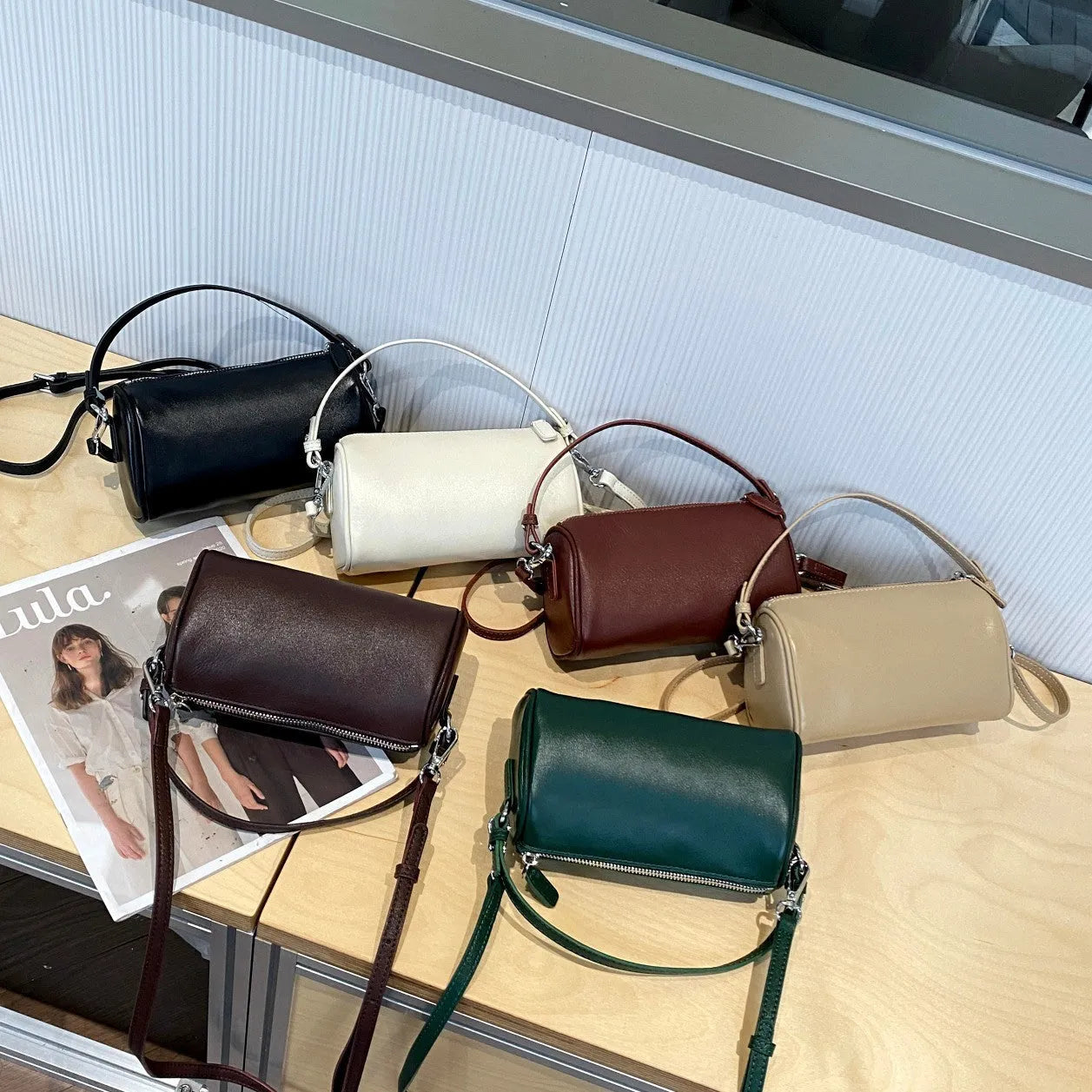 Cylindrical genuine leather crossbody bag in dark brown with contrast stitching