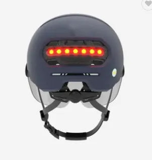 Cycling helmet with integrated red LED brake light on the back, shown in M and L sizes.