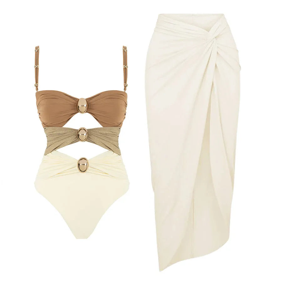 Women's solid colour one-piece swimsuit with an attached short skirt and gold button decoration.