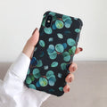 Black silicone iPhone case with a detailed leaf pattern design on the back.