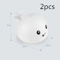 Whale-shaped electric bath toy with water spray, flashing lights, and automatic water sensing feature