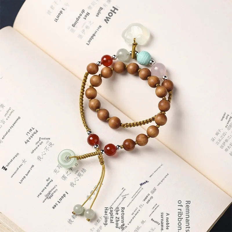 Hand-woven ebony double ring bracelet with ruyi elements in jade or chalcedony colour options