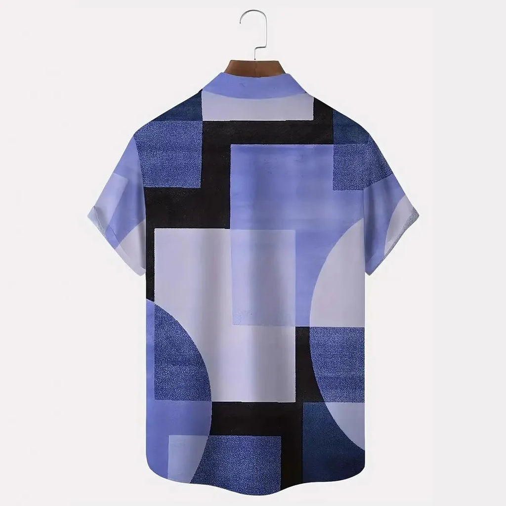 Man wearing a loose-fit cardigan shirt with a retro geometric square print in contrasting colours.