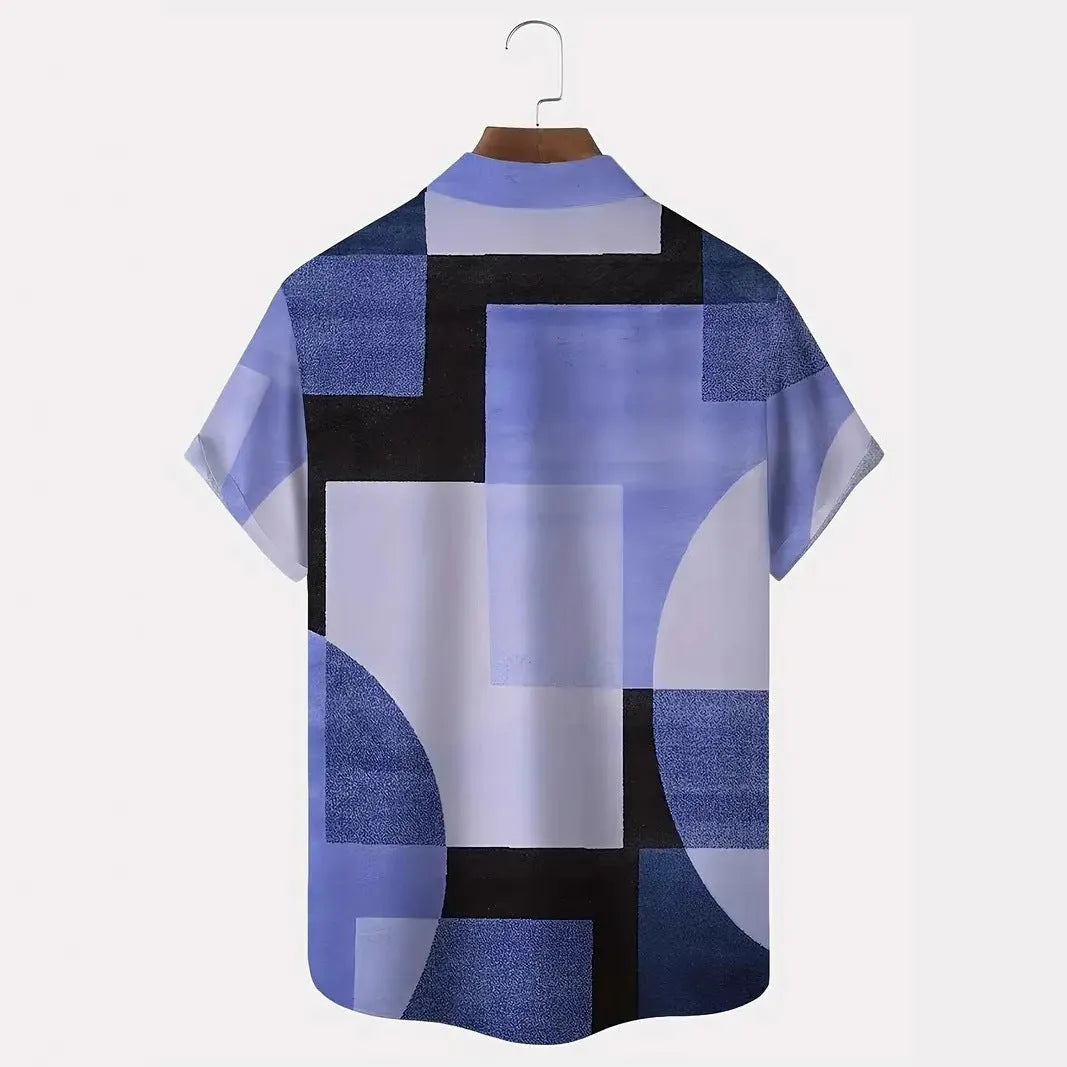 Man wearing a loose-fit cardigan shirt with a retro geometric square print in contrasting colours.