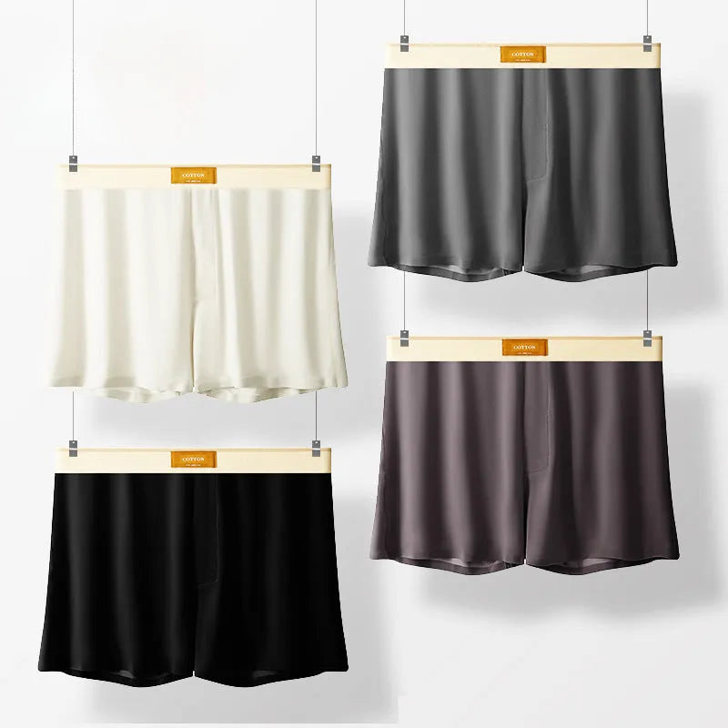 Pack of three men's solid colour ice silk boxer shorts laid flat.