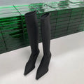 Black women's below-the-knee boots with a pointed toe, stiletto heel, and back zipper.