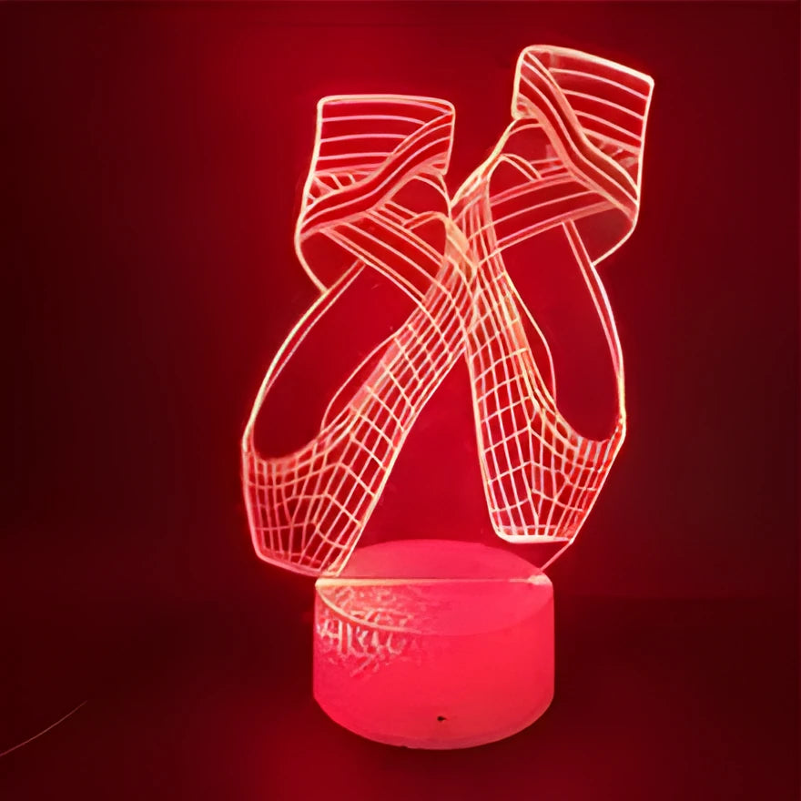 3D ballet dancer silhouette LED night light with remote control on a bedside table