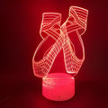 3D ballet dancer silhouette LED night light with remote control on a bedside table