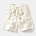 Man wearing khaki retro-style American cargo shorts made from polyester fabric.