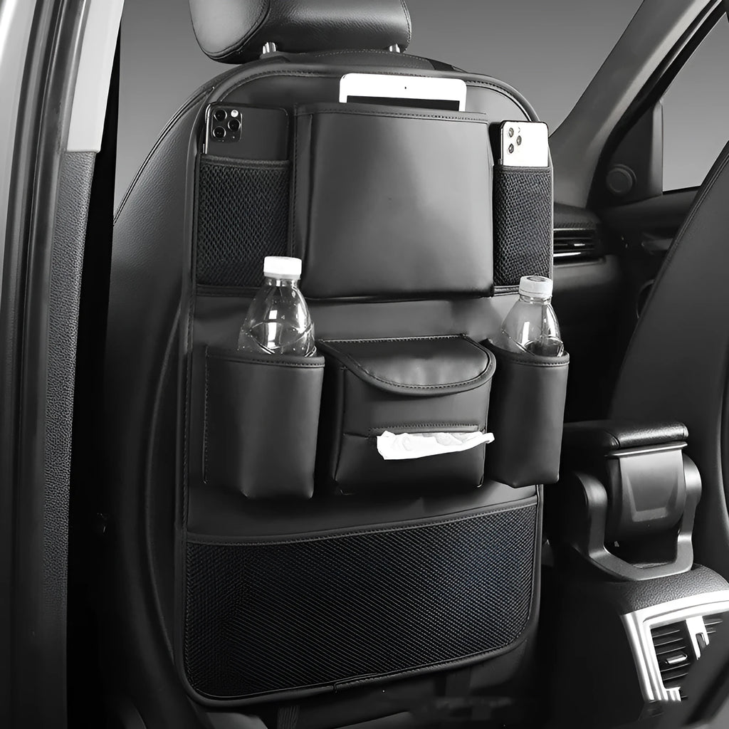 Faux leather car seat back storage organiser bag in black, shown hanging behind a car headrest.