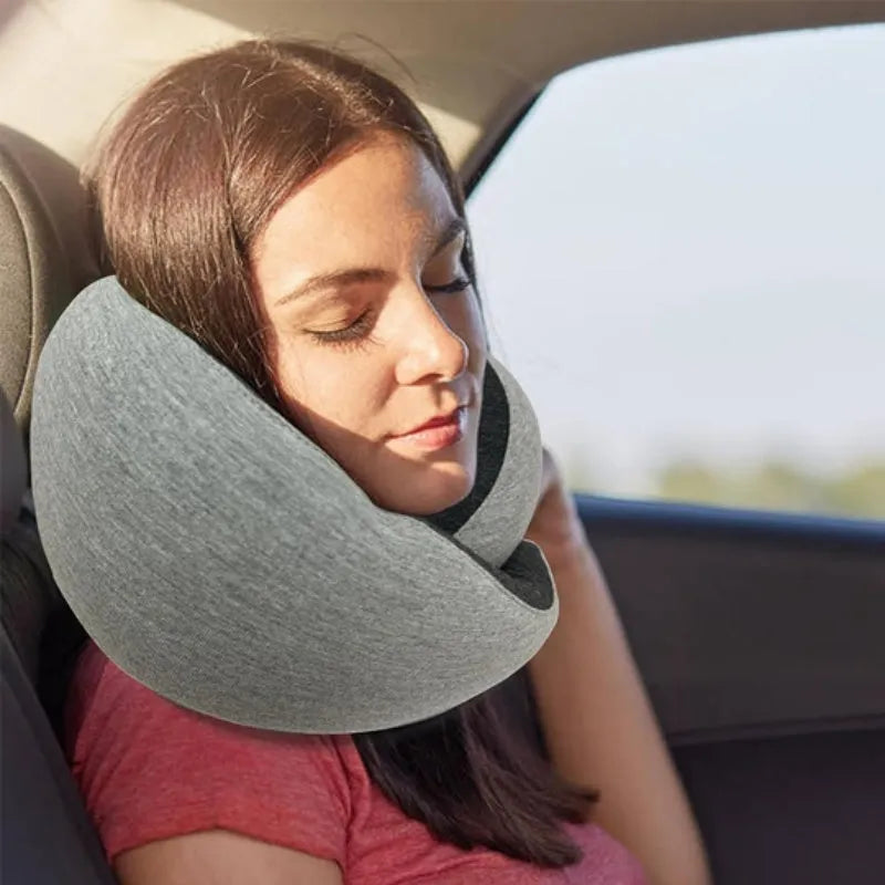 U-shaped memory foam travel neck pillow in navy blue with buckle fastening, shown rolled with carry bag