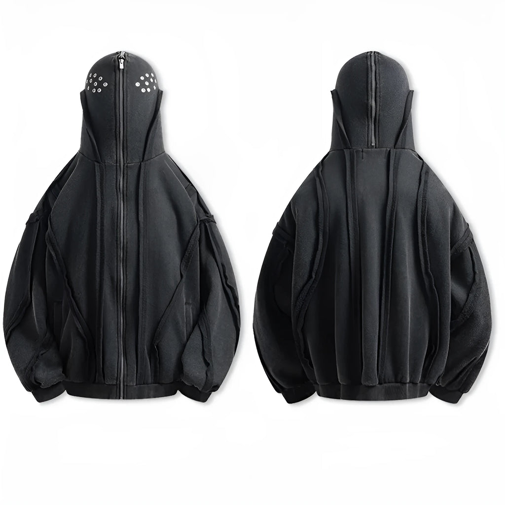 Man wearing a loose black zip-up hooded coat with a padded lining.