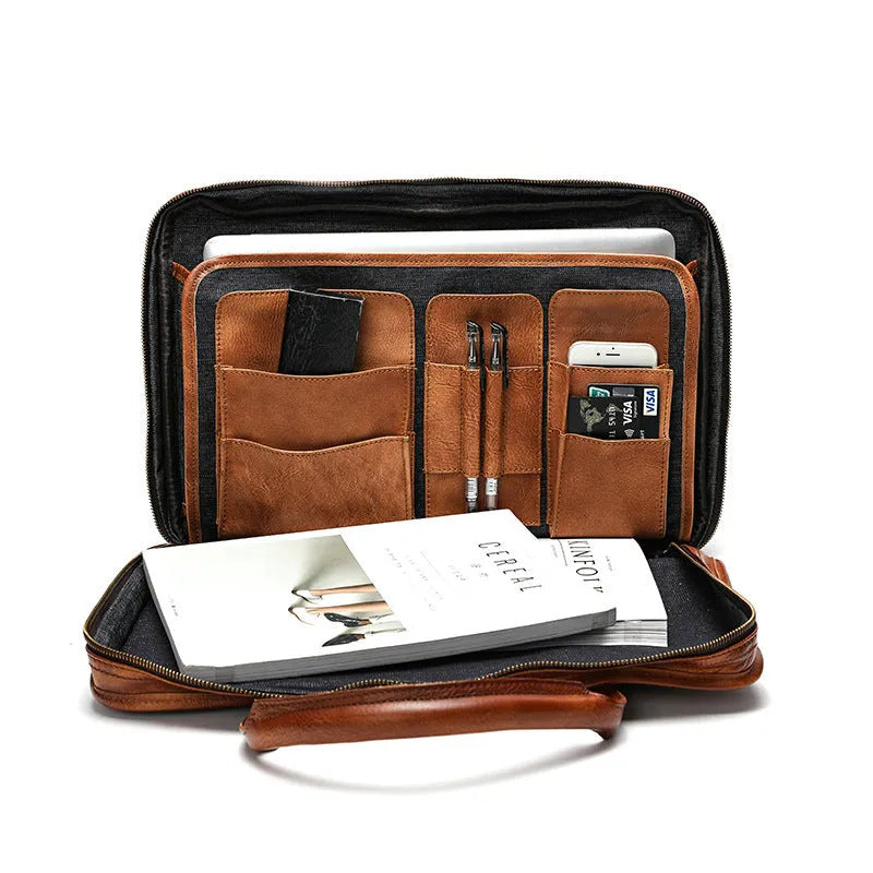 Brown vintage leather men's briefcase open to show internal laptop pocket and document organisers.