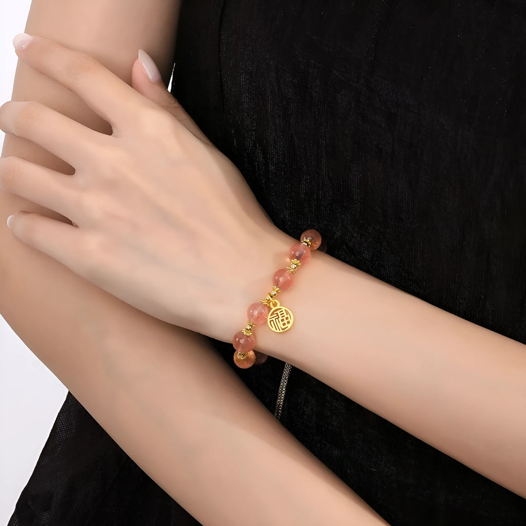 Women's strawberry quartz crystal bracelet with geometric design and fu character element