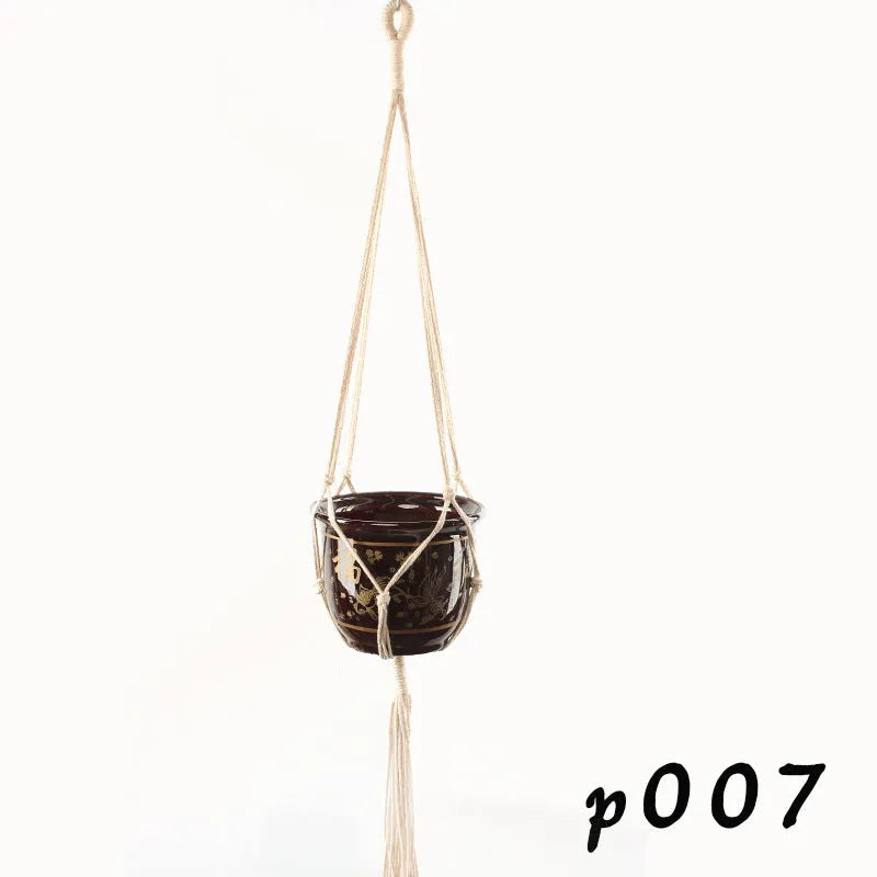 Woven wire planter basket made from cotton rope, shown in a desktop style holding a small plant.