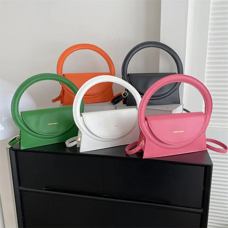 Horizontal square messenger bag in multiple colours showing stitching details and shoulder strap
