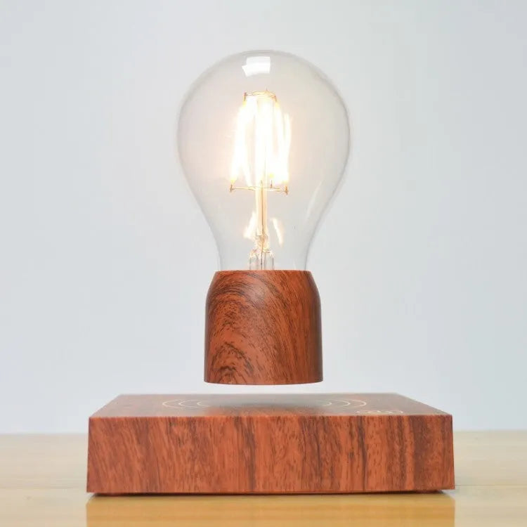 Magnetic levitation light bulb floating above wood-effect base with international plug adapters
