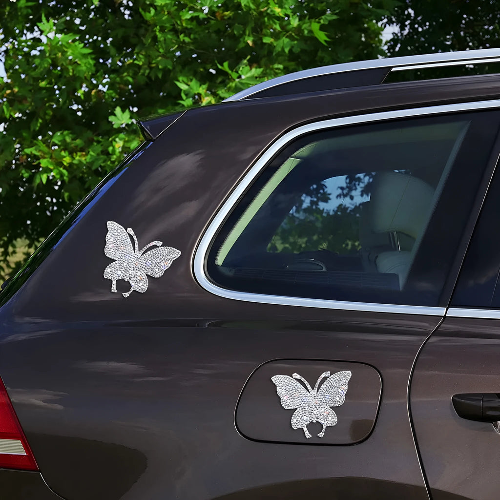 Close-up of a diamond-encrusted bear paw and butterfly design on a 7x6cm glass car sticker.