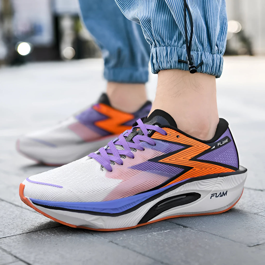 Marathon carbon plate racing running shoes in orange colour, showing low-top design and platform heel.