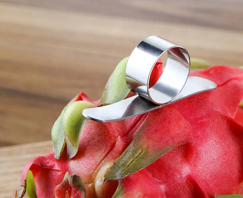 Silver stainless steel finger ring fruit peeler for citrus and pomegranates.