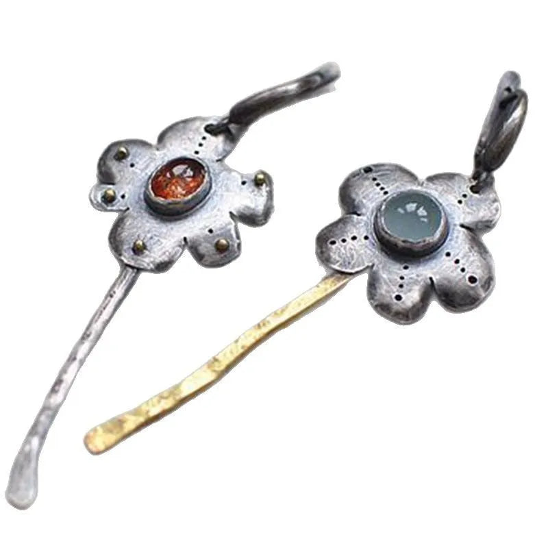 Long retro earrings with two-tone floral geometric design in alloy with electroplated finish.
