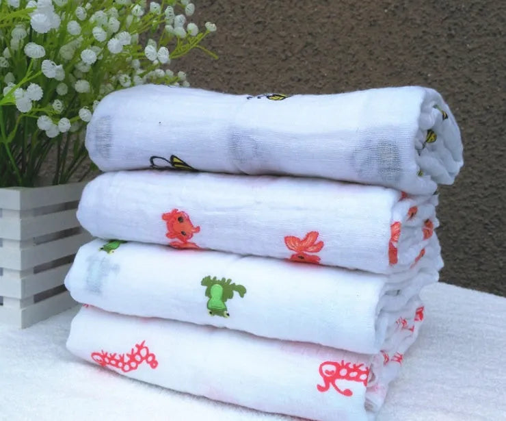 Cotton gauze baby blanket 120x120cm in balloon elephant style folded on a light background