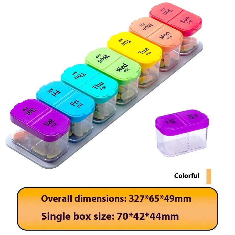 Extra large white and rainbow plastic pill organiser box with 14 removable grid compartments open on a table.