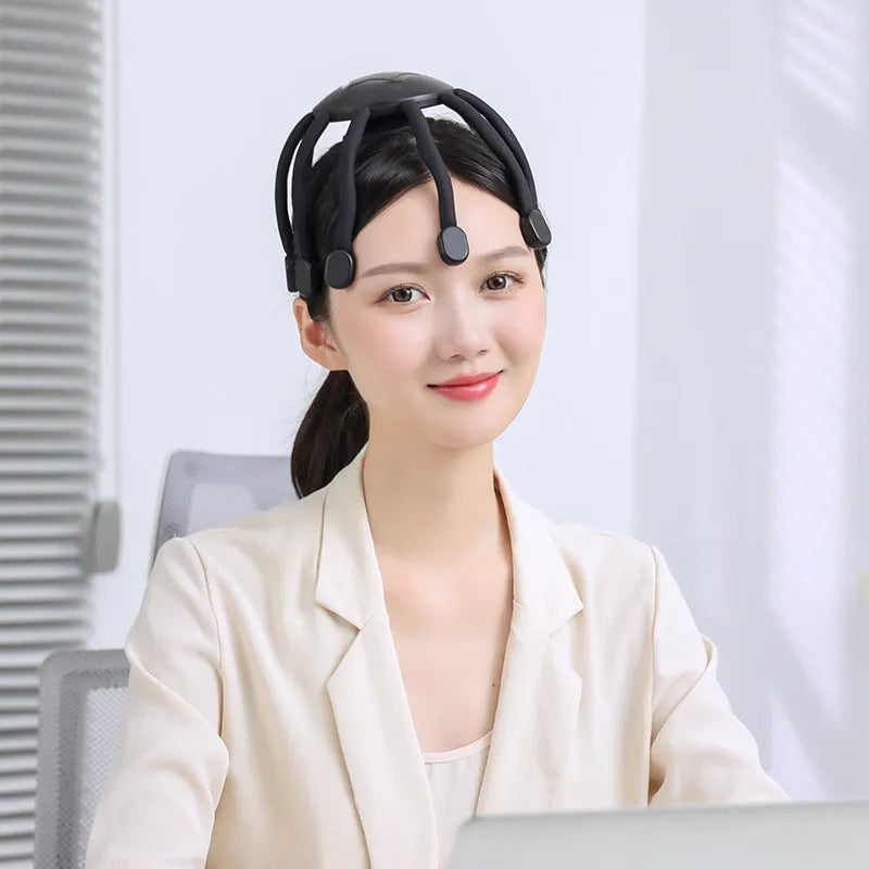 Black eight-claw electric head massager with USB cable on white background.