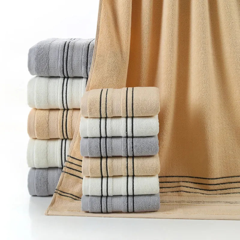 Cotton towel set showing white, grey and khaki bath towels with 34x74cm and 70x140cm dimensions