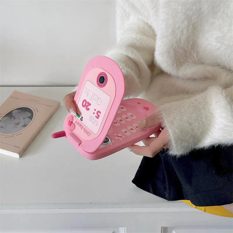 Pink silicone iPhone case with a flip-open mirror cover on a table.