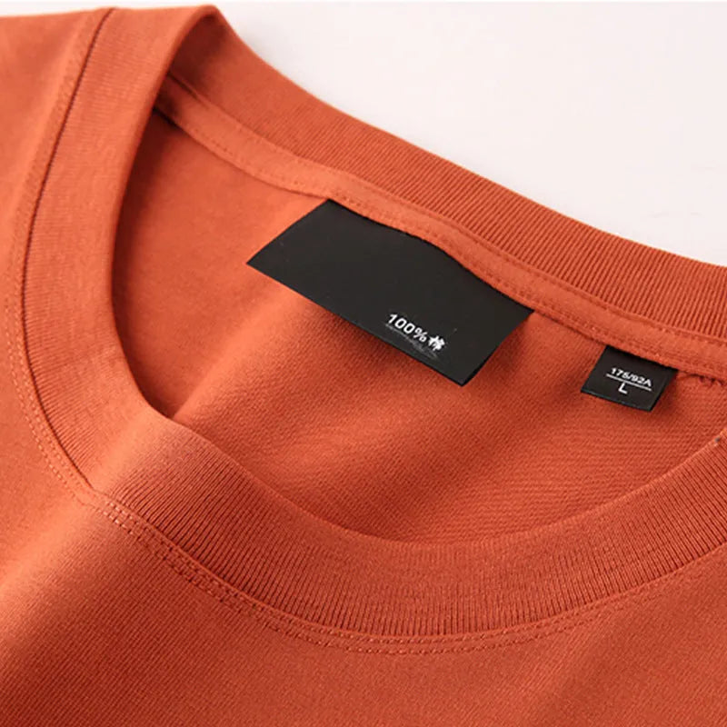 Men's loose fit casual cotton T-shirt in a solid colour with a round neck and drop shoulders.